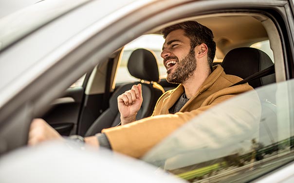 happy man driving car