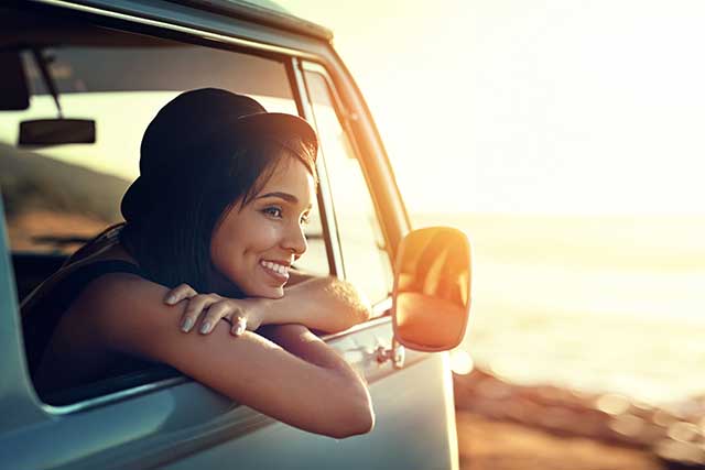 Young women looking out the car at scenery