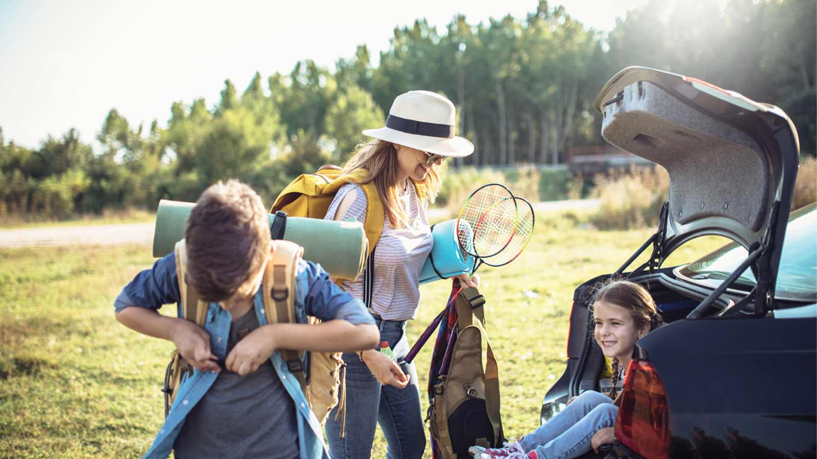 family ready to go explore outdoors. mom with play toys and child smiling