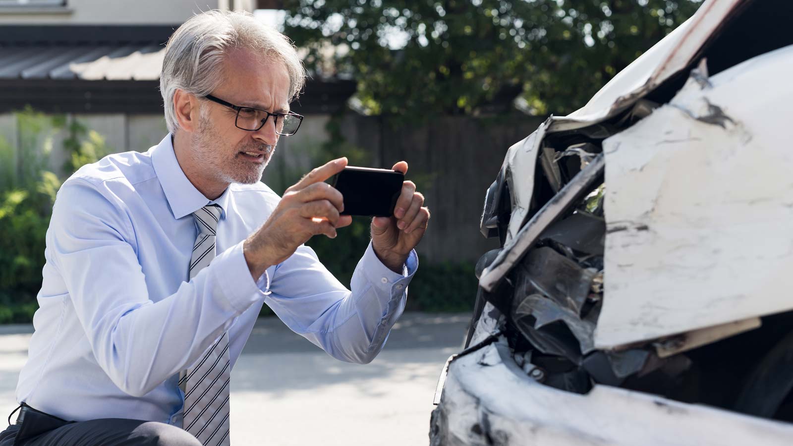 a person taking a photo of a car accident