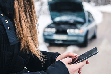 a person on the phone after their car broke down