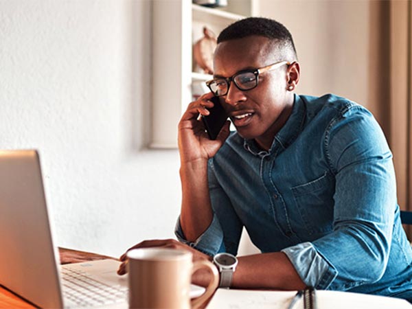 a person at home on the computer and phone